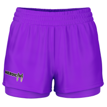 Purple athletic shorts with a double-layered leg design, featuring a small 'HEROIC U' graphic on the right leg, set against a plain white background.